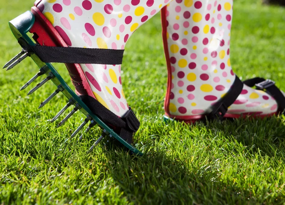 Woman using aerator shoes to aerate lawn
